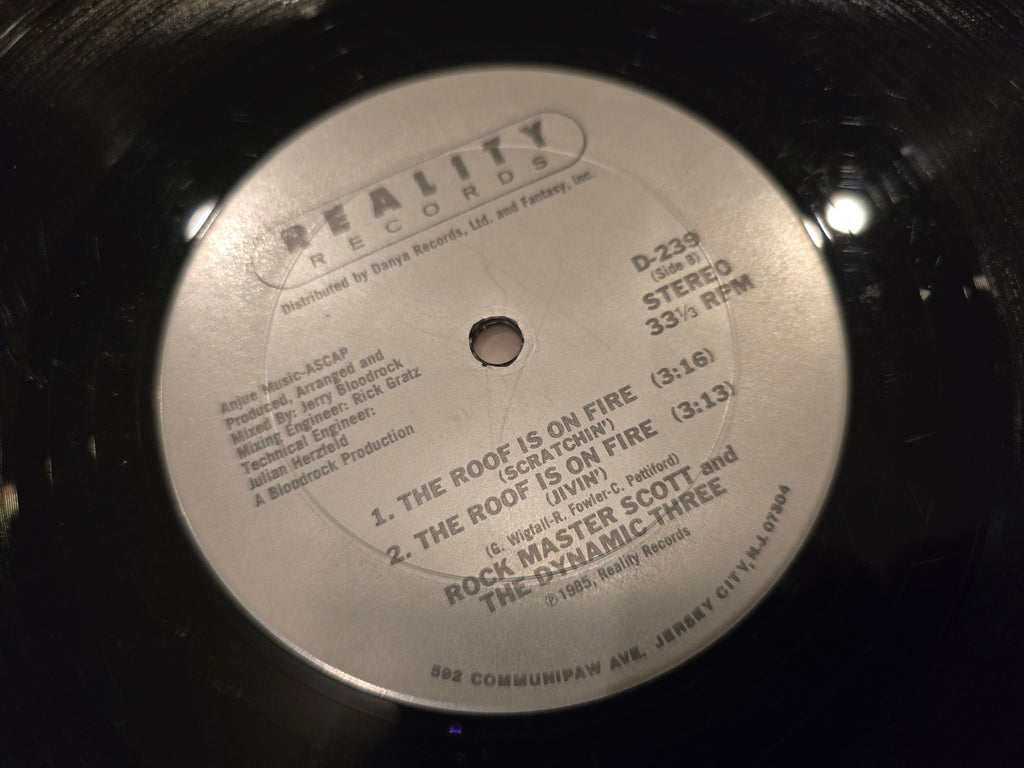 Rock Master Scott & the Dynamic Three – The Roof Is on Fire (12" Single, Reality Records, D-239)