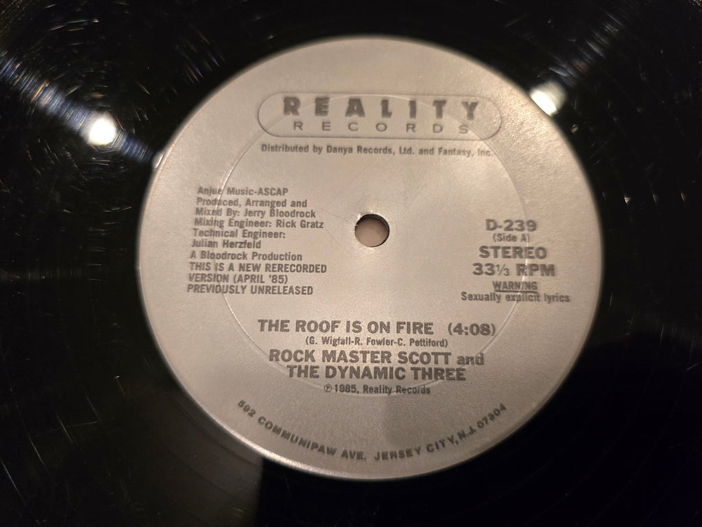 Rock Master Scott & the Dynamic Three – The Roof Is on Fire (12" Single, Reality Records, D-239)